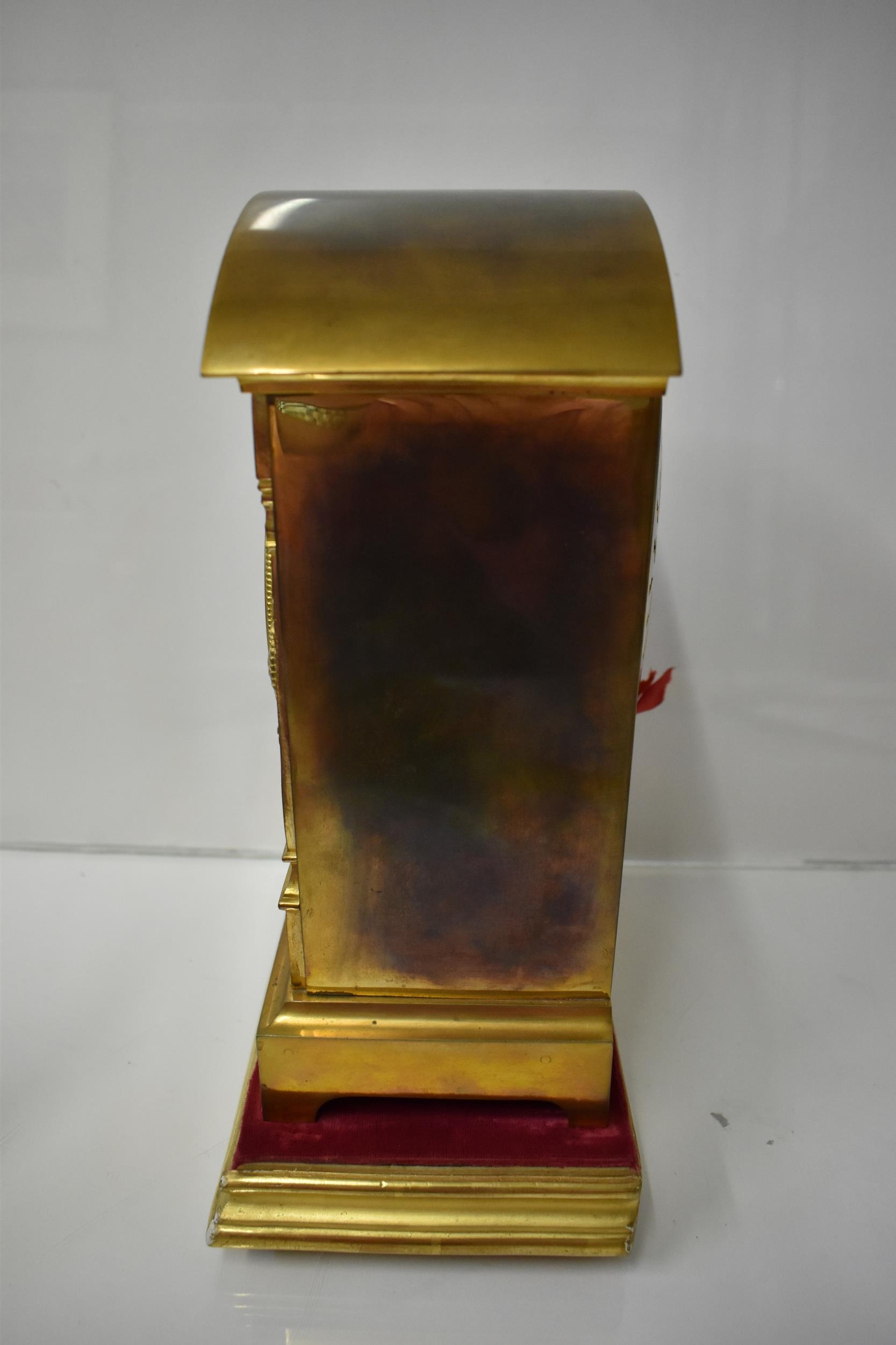 An early 20th century brass mantle clock on a gilded treen stand, the arched top case with floral - Image 2 of 5