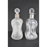 Two early 20th century clear glass glug glug decanters, one with a silver collar, Birmingham 1902 by