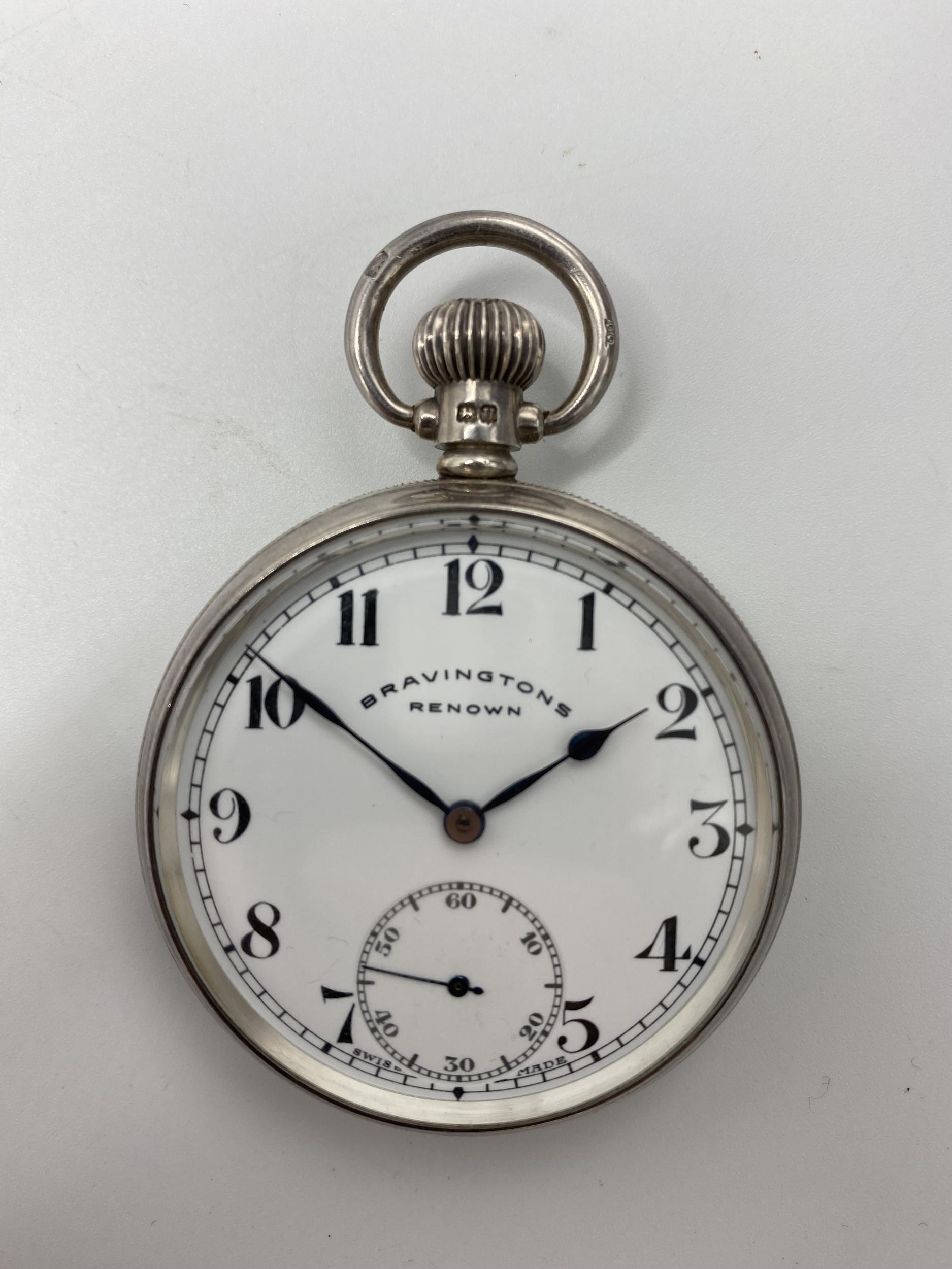 An early 20th century silver open faced keyless wound pocket watch, the white enamel dial signed '