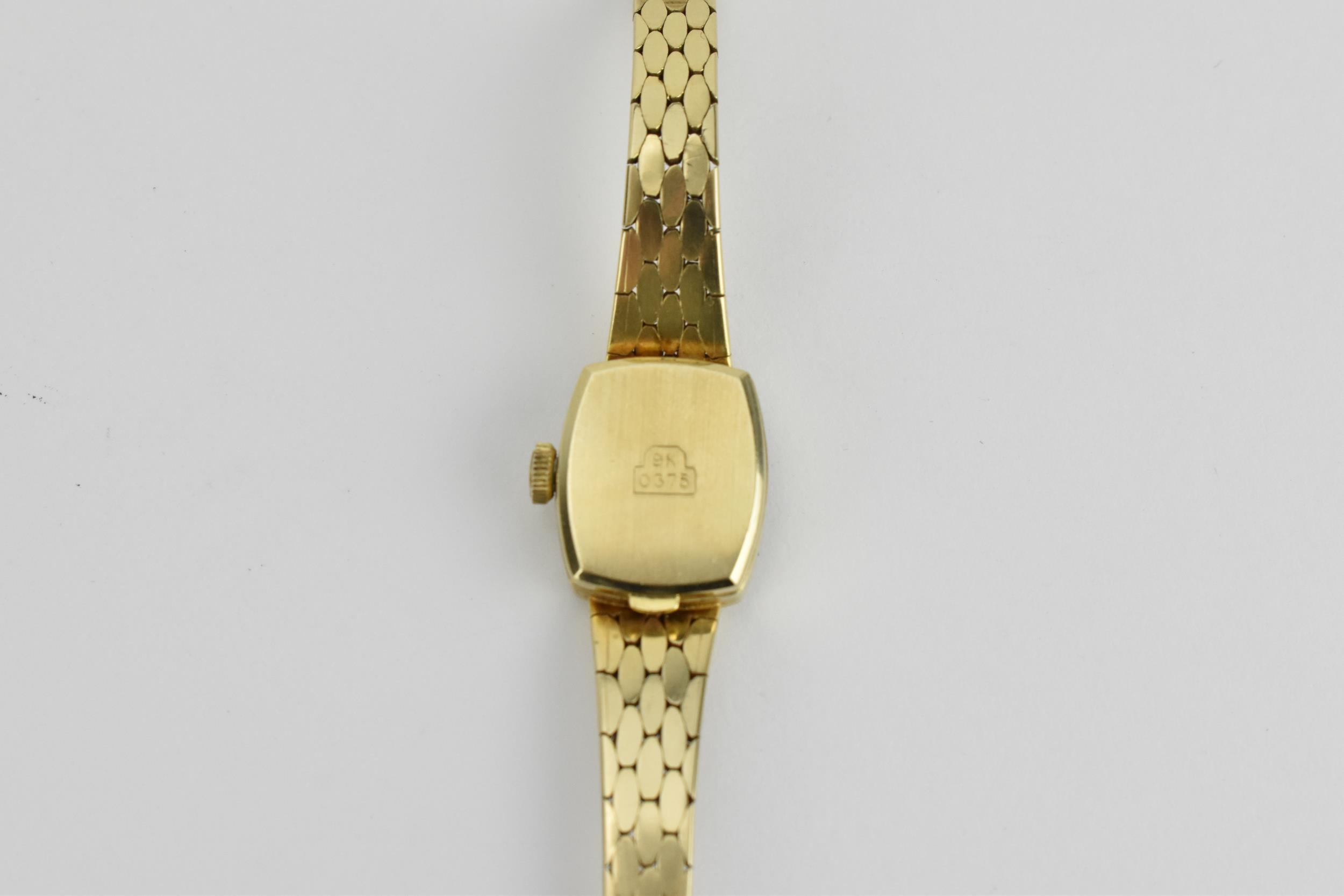 A ladies Bulova 9ct gold wristwatch having black baton hour markers and Bulova logo signed crown, on - Image 3 of 4