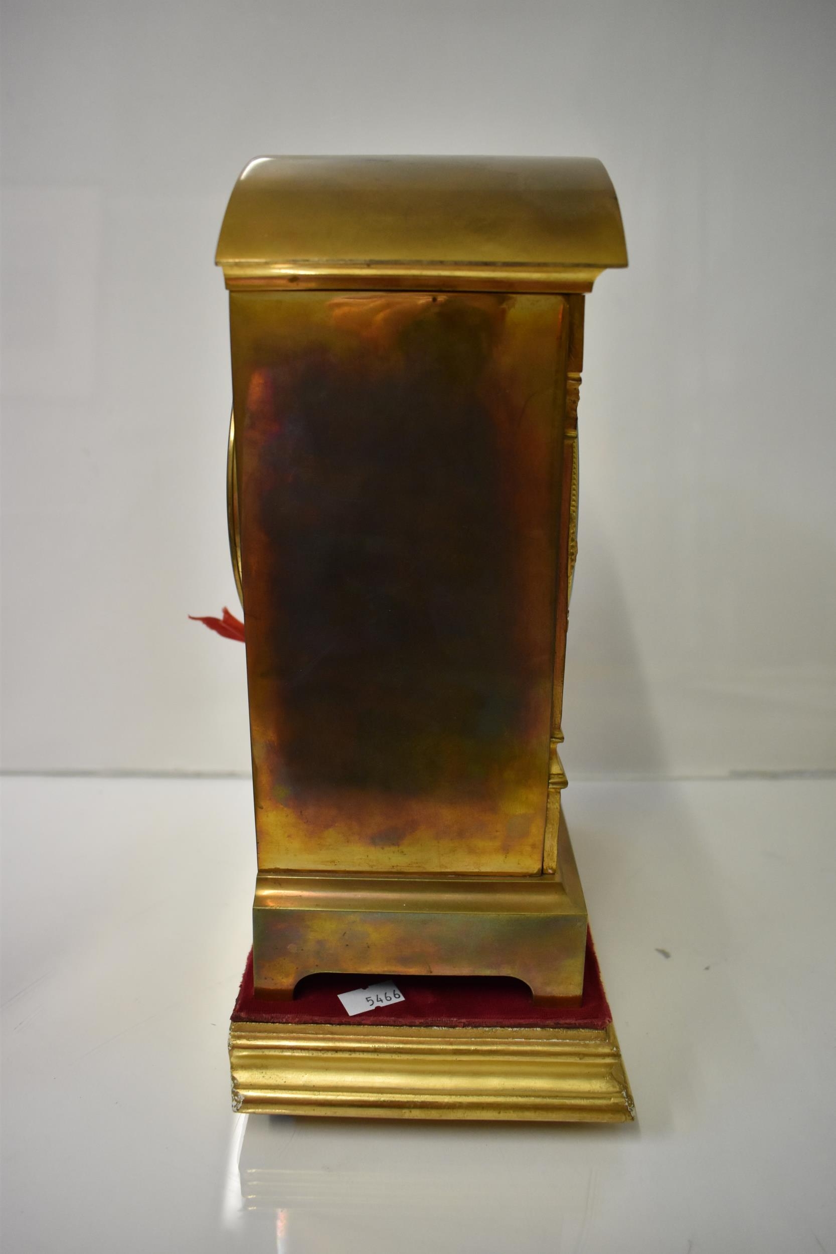 An early 20th century brass mantle clock on a gilded treen stand, the arched top case with floral - Image 4 of 5