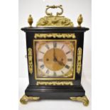 A 19th century ebonised and gilt metal mantel clock by Payne & Co, the case having gilt metal top