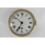 An early/mid 20th century brass cased ships bulkhead clock, the 6 inch dial having Roman numerals,