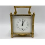 An early 20th century square formed alarm carriage clock, the white enamel dial having Arabic