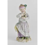 A 19th century Meissen figure of a girl holding a toy lab with incised mark to the back and cross