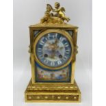 A late 19th century French gilt metal and porcelain mantle clock, the porcelain panels decorated