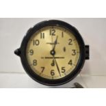 An early/mid 20th century bulkhead ships clock in a black bakelite case, the dial having Arabic