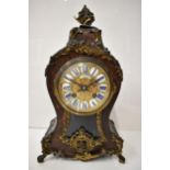 A late 19th century French Boulle mantle clock, the red tortoiseshell case having a metal basket