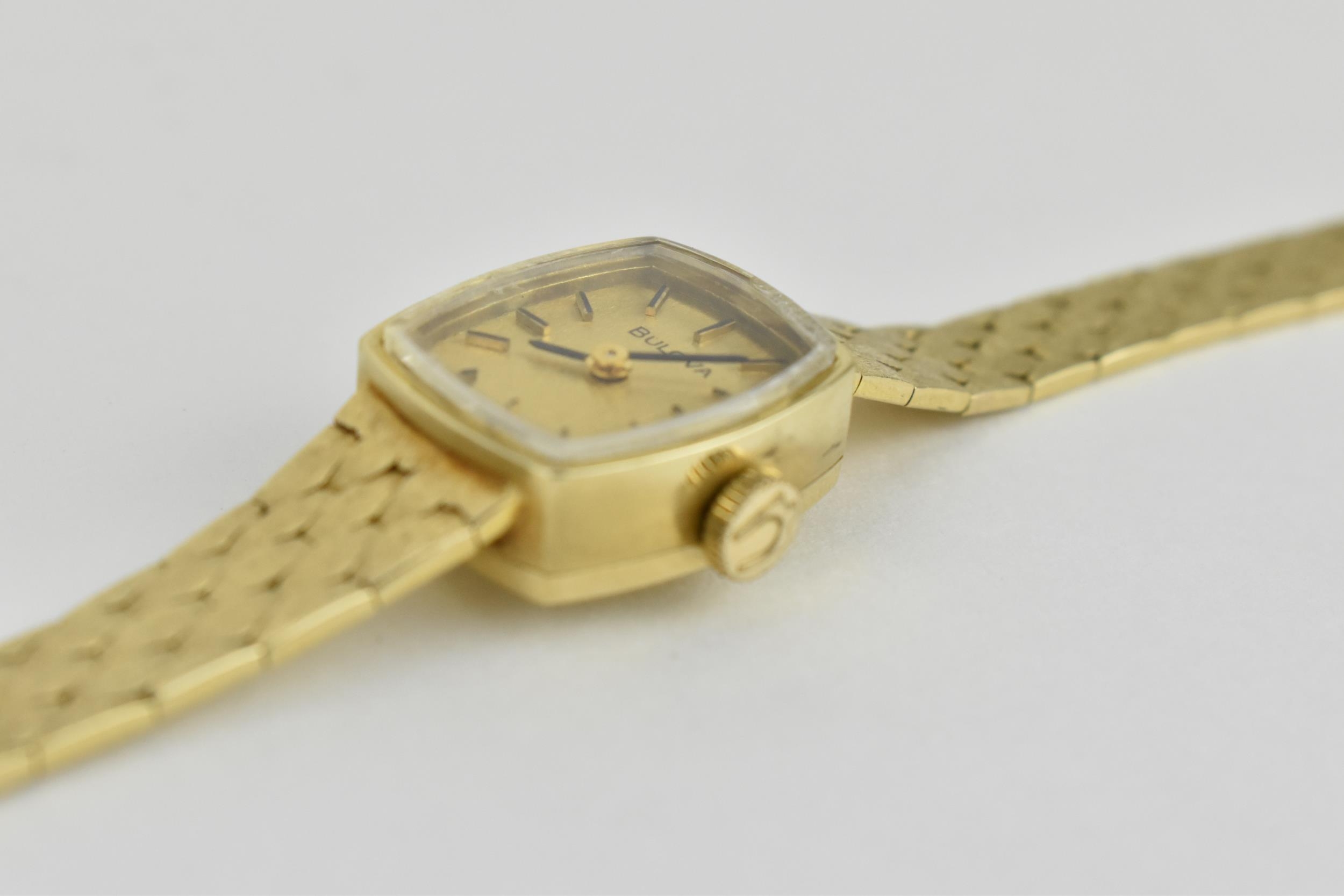 A ladies Bulova 9ct gold wristwatch having black baton hour markers and Bulova logo signed crown, on - Image 4 of 4