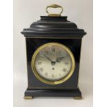 A George III ebonised bracket clock having a bell top case with gilded highlights, the silvered dial