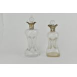 Two late Victorian clear glass glug glug decanters, each with a silver twin spouted collar, London