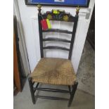 An arts & crafts ladder back chair with painted decoration and a rush seat Location: