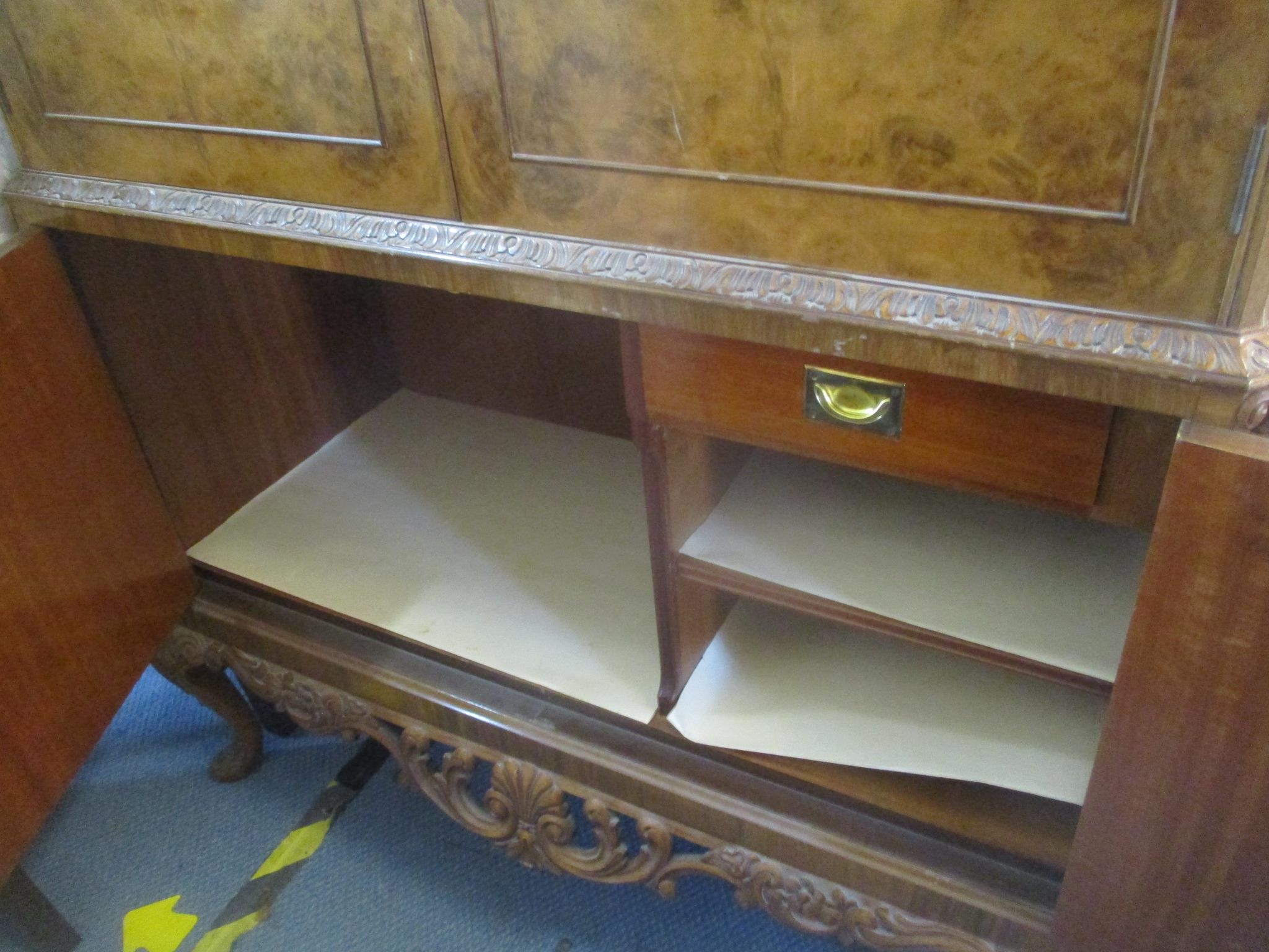 A 1950's walnut cocktail cabinet having four cupboard doors with fitted interior standing on short - Image 4 of 4