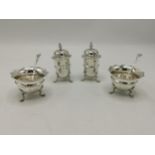 A 20th century silver cruet set to include salt and pepper pots and two salts, 157g Location: Port