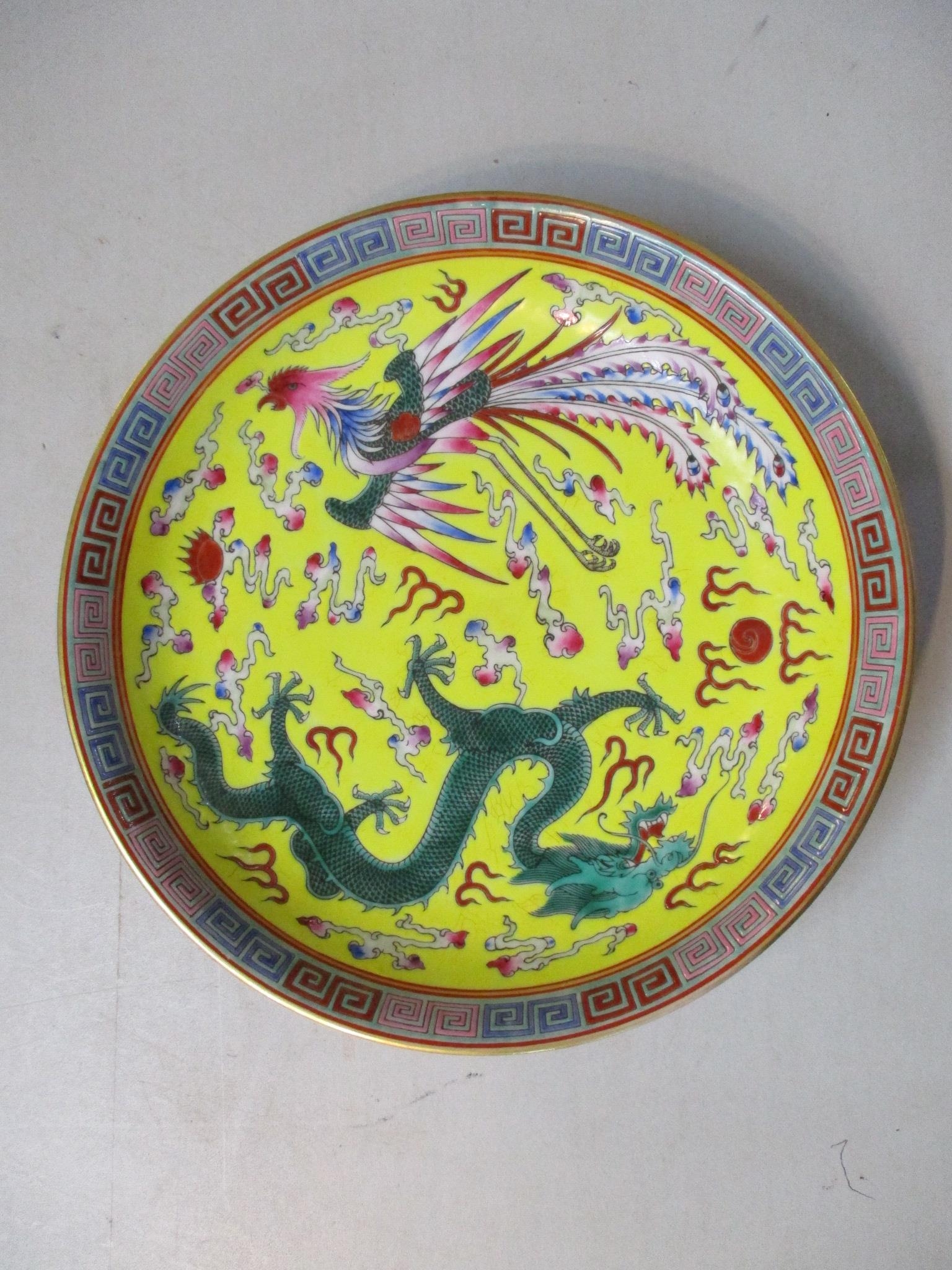 A Chinese porcelain large famille rose export saucer dish decorated with a dragon and a phoenix