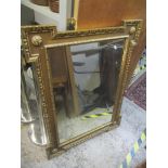 A late 19th/early 20th century large wall hanging mirror having gilt highlights, with sausage and