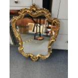 A 20th century Rococo style gilt wood mirror, 69cm x 53cm Location: RWF