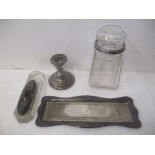 Silver to include a dressing table tray, a nail buffer and stand and a glass bottle with a silver