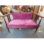 An Edwardian inlaid mahogany sofa with velour upholstery, raised on reeded legs, 77 h x 120 w x 66cm