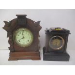 A Victorian black and brown marble cased mantel clock, and a carved walnut cased mantel clock