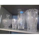 Cut glassware to include an intricate large vase and lidded bowl, along with two other vases