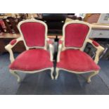 A pair of 20th century Louis XV style cream painted fauteuils with pink velour upholstery, raised on