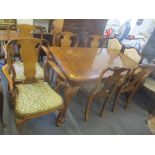 A 1950's walnut Queen Anne style extending dining table and six chairs, two being carvers, 76cm h