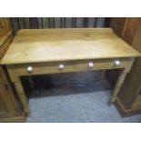 A Victorian pine side table having two inset drawers and on turned legs, 81.5cm h x 106 cm w