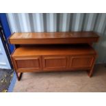 A mid 20th century McIntosh teak mid height sideboard with three drawers, over a shelf and three