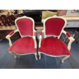 A pair of 20th century Louis XV style cream painted fauteuils with pink velour upholstery, raised on