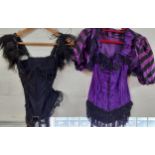 Two Burlesque basques, one in black with a full length beaded attachment and the other in purple