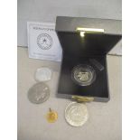 A yellow metal Iranian coin, 1.8g, together with a Sultanate of Oman 5-rials coin, a silver