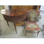 A late 19th/20th mahogany nursing chair together with a demi lune side table with tambour front