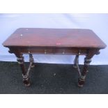 An early 20th century oak Gothic Revival side table having two inset drawers, turned column supports