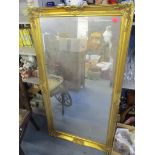 A gilt framed wall mirror, 135cm x 73cm Location: