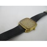 A 1970's Omega gents gold coloured dial wristwatch with date aperture and black leather strap