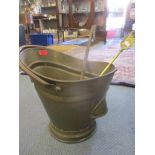 An early 20th century brass coal bucket and two irons Location: