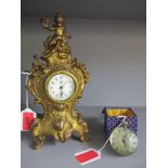 A modern brass and glass ball clock, and an American gilt metal baroque style clock Location: