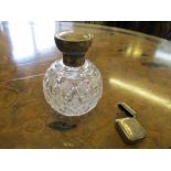 A silver topped cut glass dressing table bottle with glass internal stopper, and a silver vesta case