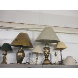 Six modern table lamps, mostly gold coloured in various designs with shades Location: BWR