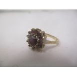 A 9ct gold ring set with garnets Location: