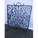 An Arts & Crafts wrought iron fire guard decorated with a tree and a snake 66.5cm h x 52.5cm w