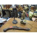 A brass finished reproduction candlestick telephone, and a resin ornamental candlestick telephone,