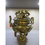 A Chinese cast bronze censor decorated with grape and vine leaves, on three rusticated legs, the
