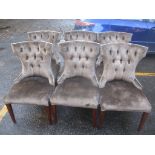 A set of six modern brown velour dining chairs with mid stained legs, button backs and stud detail