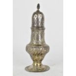 An 18th century silver pepper pot, possibly by T *, London 1778, of baluster form with embossed
