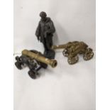 A Victorian cast spelter figure of a man, and two model cannons Location: G