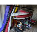 A selection of wind surfers and lots of accessories to include boards, sails, masts, booms,