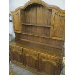 A reproduction oak dresser having plate rack above drawers and cupboards, 202cm h x 167cm w
