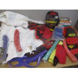 A selection of Karate accessories to include robes, belts, pads, books and other items Location: